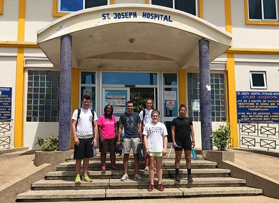 Dr. Ateh (second from left) with PC students during the Ghana Maymester trip in 2018.
