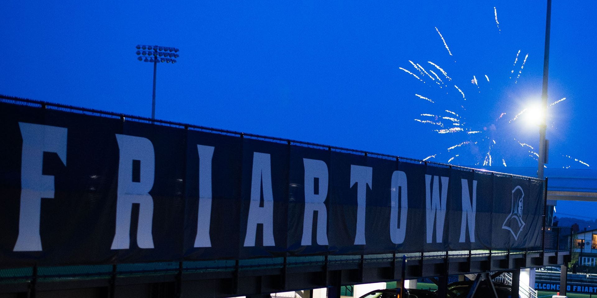 friartown sign with firework