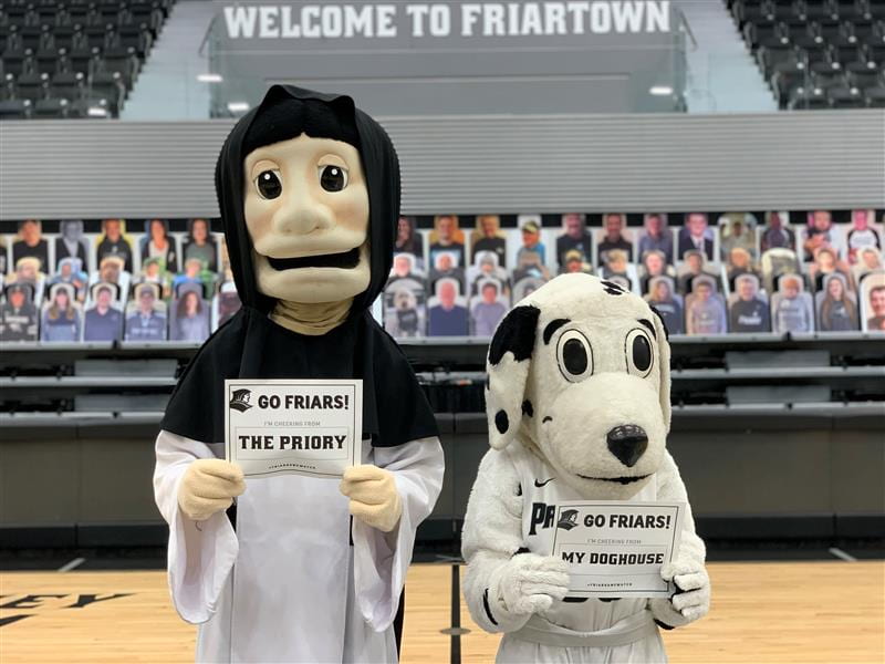 providence college mascots holding signs to cheer for the men's basketball team